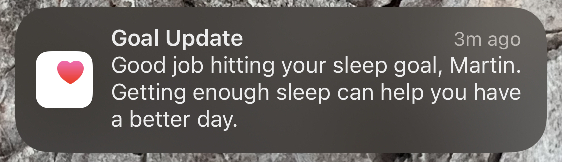An iPhone Screenshot of an Apple health notification telling me I hit my sleep goal.